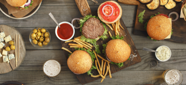 Cheeseburgers and fries on a cutting board