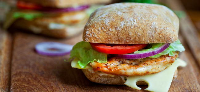 Chicken sandwich with lettuce, onions and tomatoes