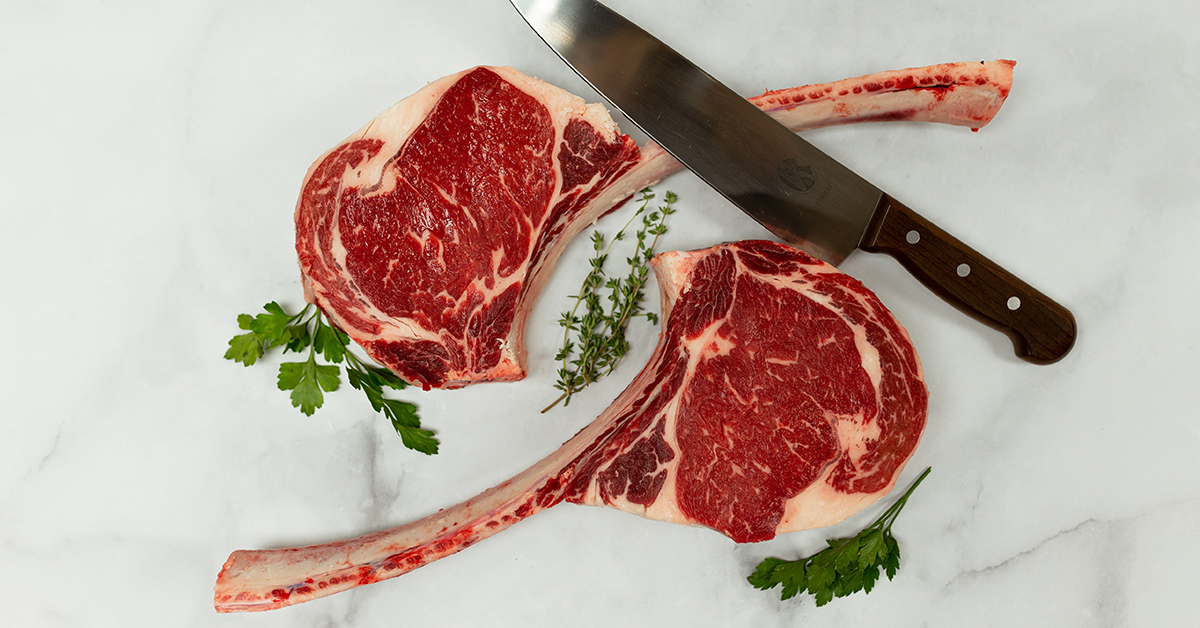 Two tomahawk steaks with rosemary and thyme