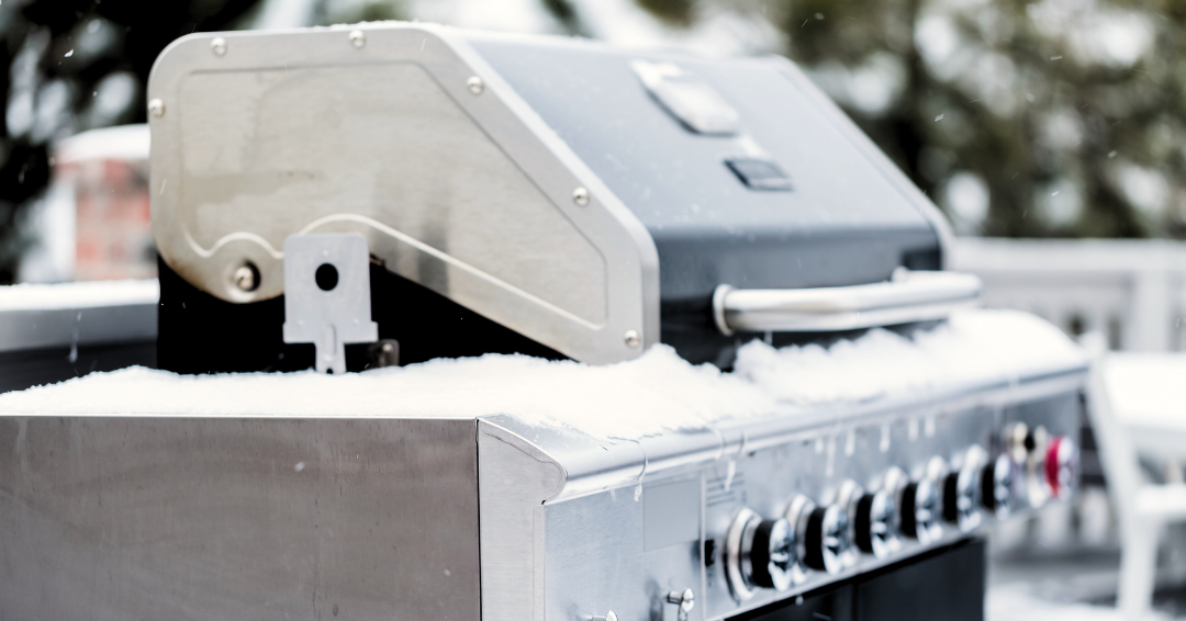 bbq grill with a light covering of snow