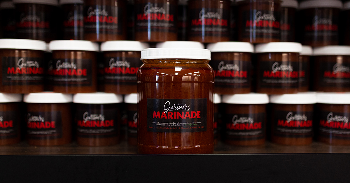 Rows of Gartner's Marinade with one larger jar of marinade in front of the rest