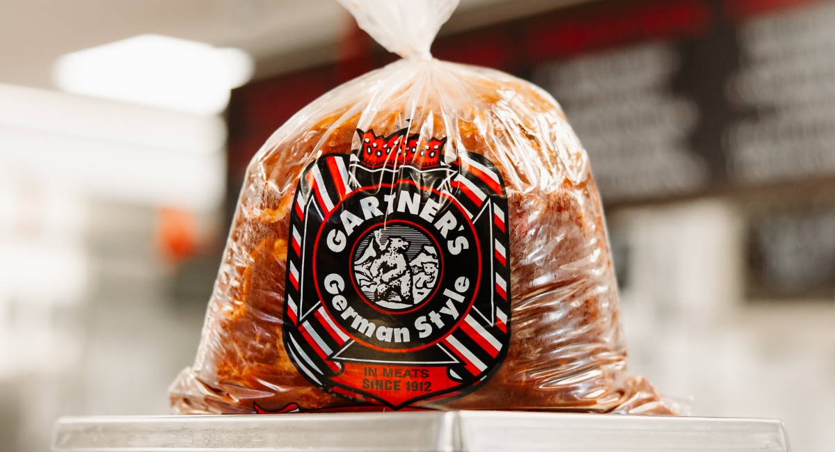 back-to-school dinners, bag of marinated meat with Gartner's logo on it sitting on a scale in the store