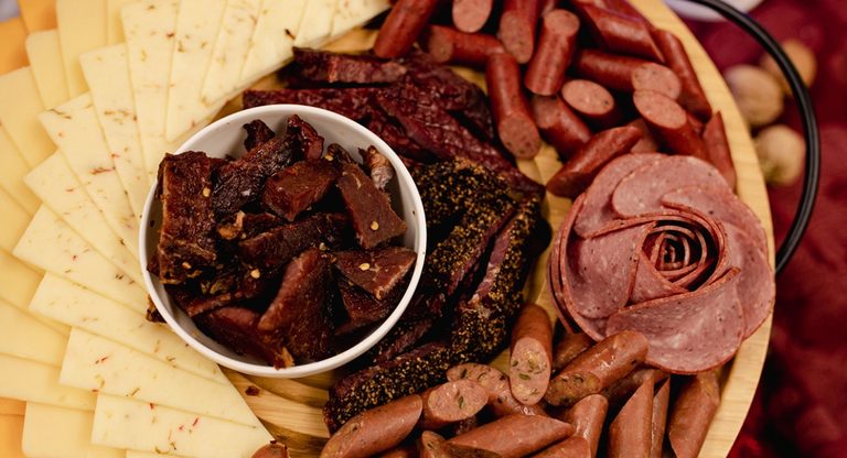 game day grab-and-go snacks - pepperoni, beef jerky, salami and cheeses on a platter